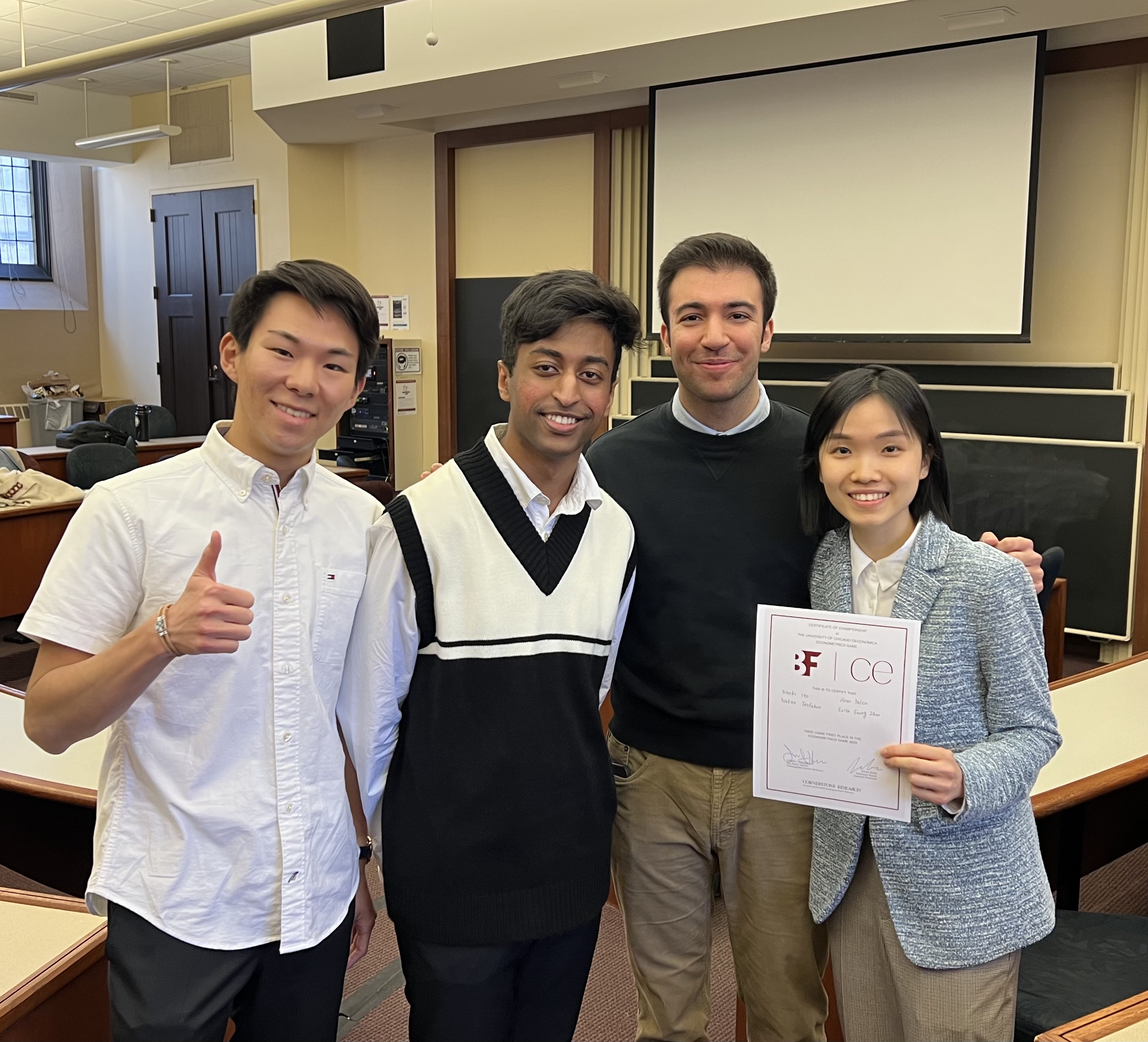 Northwestern's winning team members stand holding the certificate they received for winning the competition.