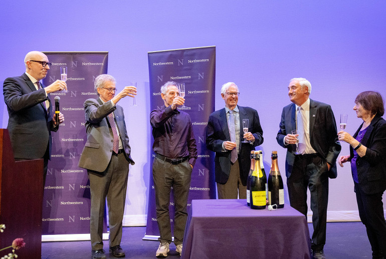 Prof. Joel Mokyr and colleagues toast to the news.